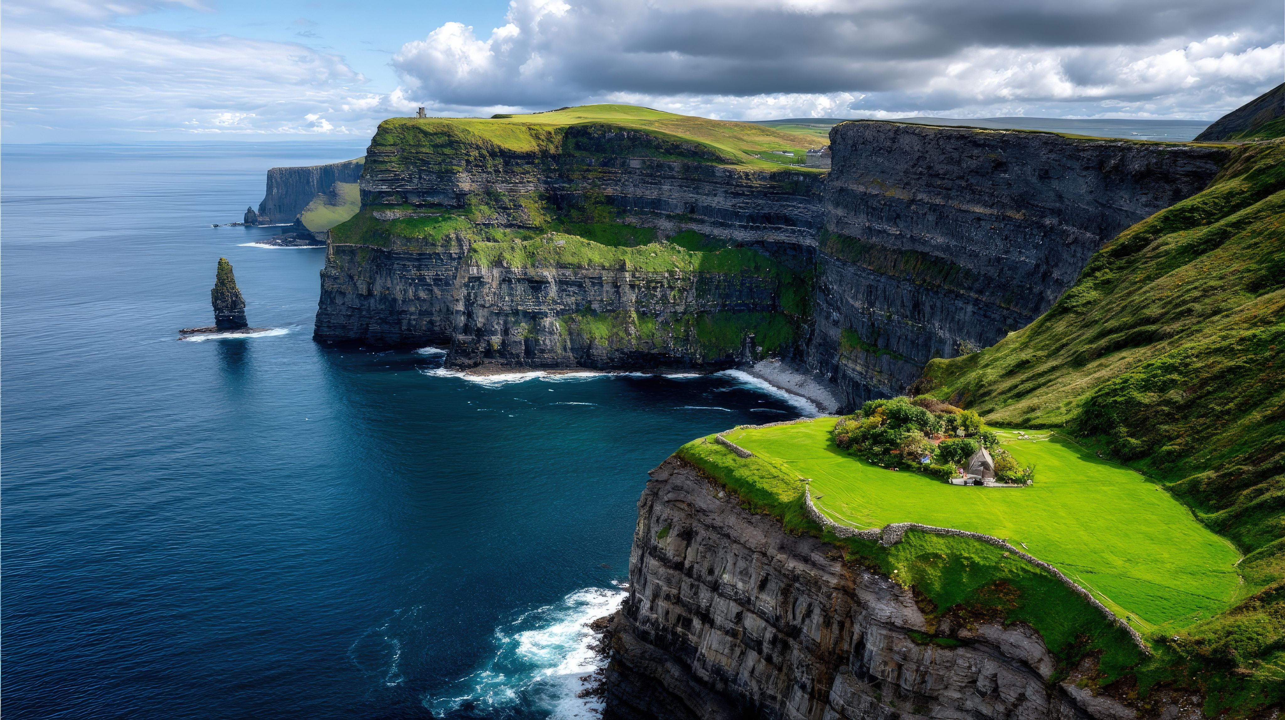 a black and white photo of a beach with a mountain in the background