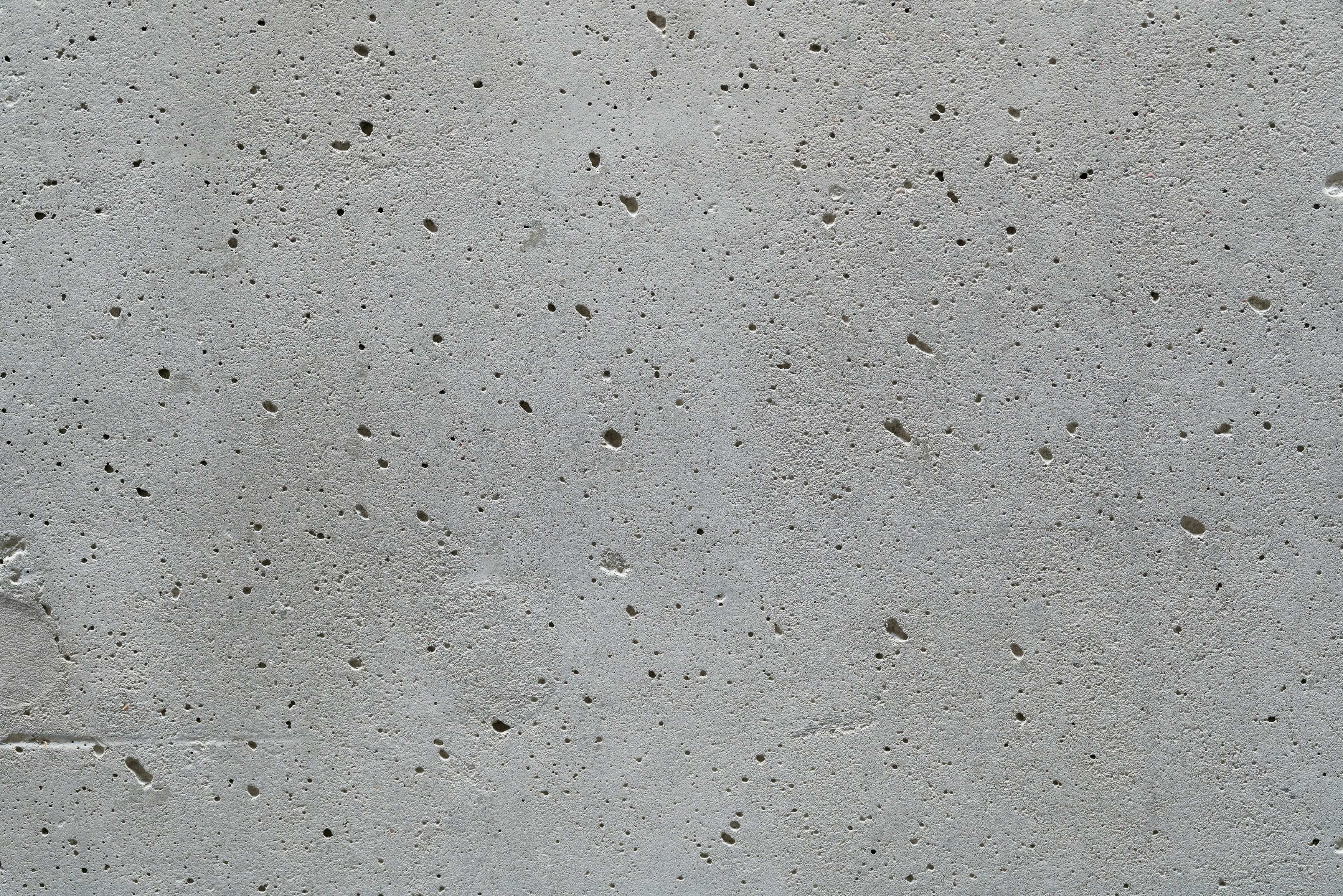 a cement wall with small holes in it
